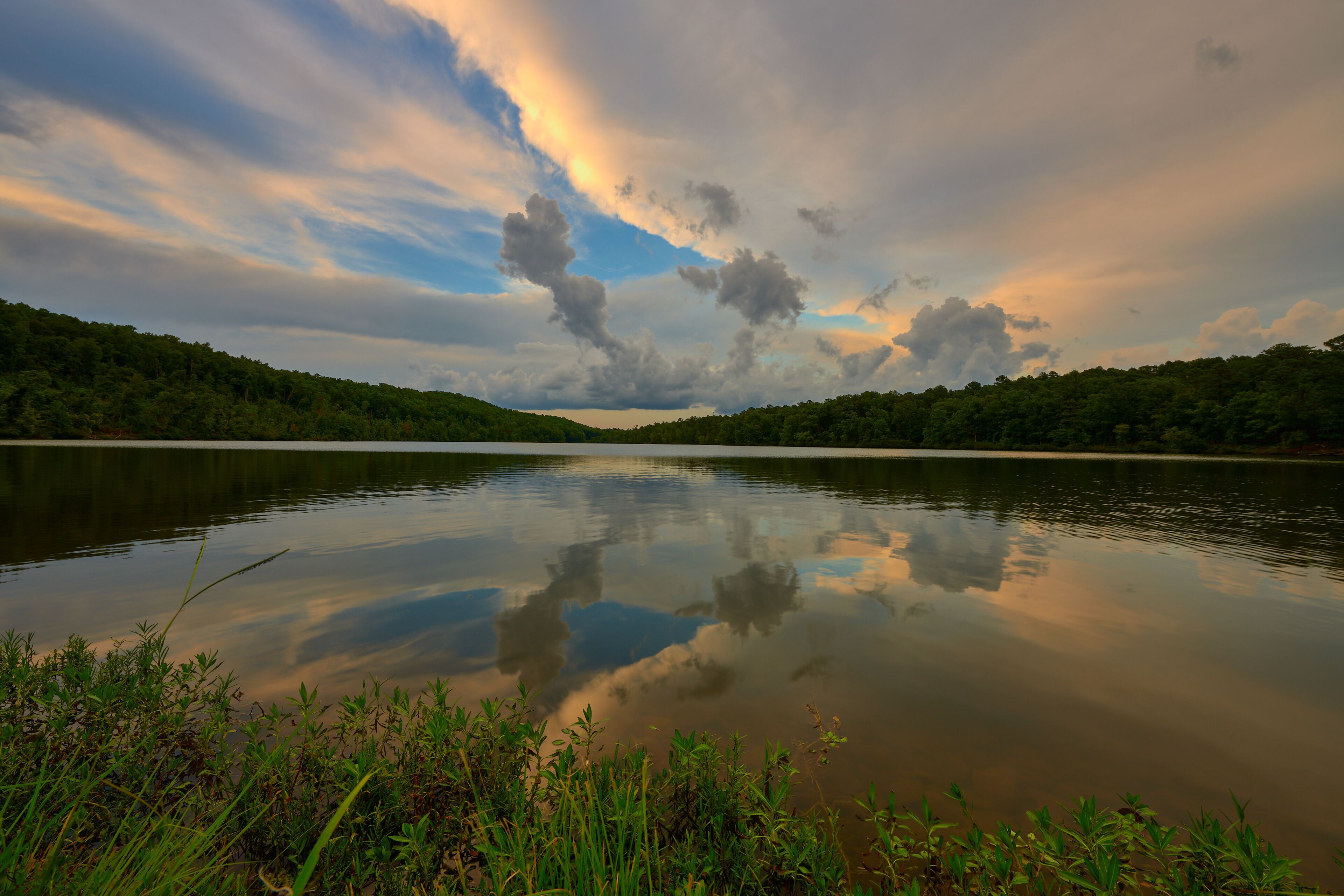  Dramatic sky and beautiful reflections of summer evening at the park