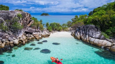 Aerial drone view of in kayak in crystal clear lagoon sea water during summer day near Koh Lipe island in Thailand. Travel tropical island holiday concept