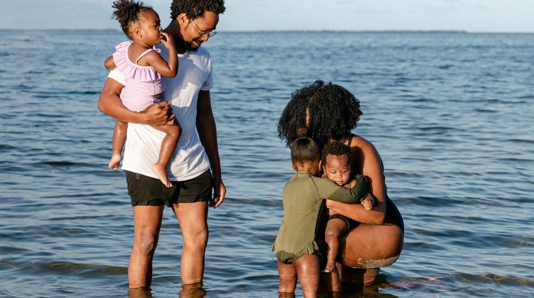Sister hugging her brother at the beach