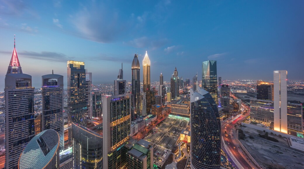 Skyline view of the high-rise buildings on Sheikh Zayed Road in Dubai aerial day to night timelapse, UAE.