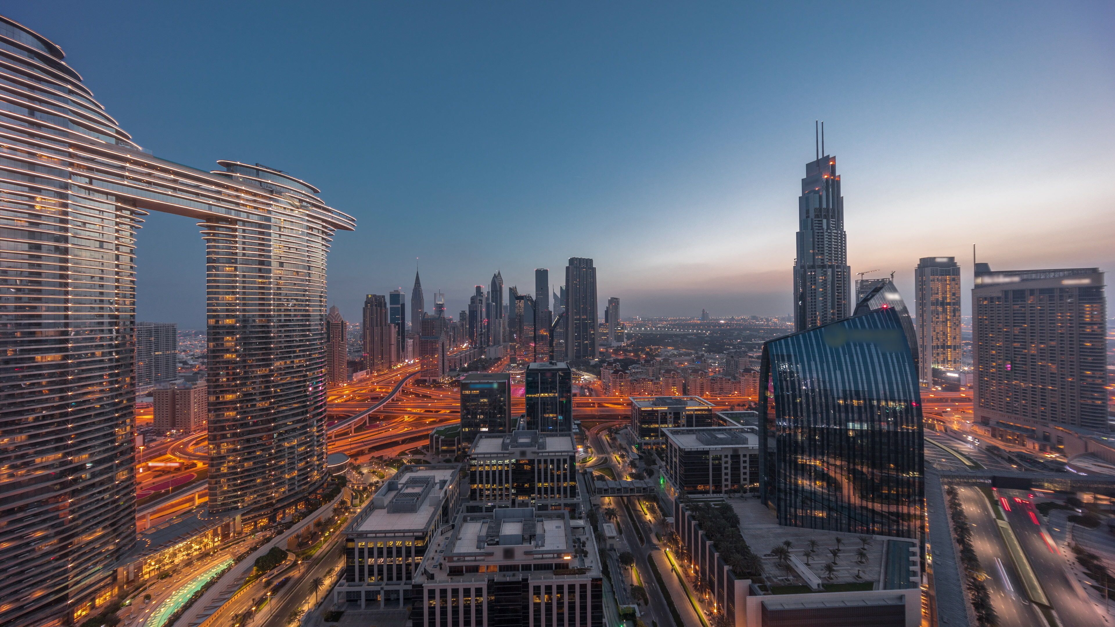 Futuristic Dubai Downtown and finansial district skyline aerial night to day timelapse.