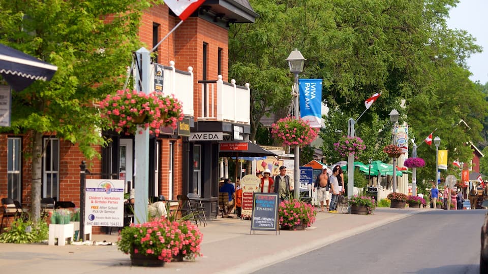 A street lined with shops, including a hair salon and a cafe.