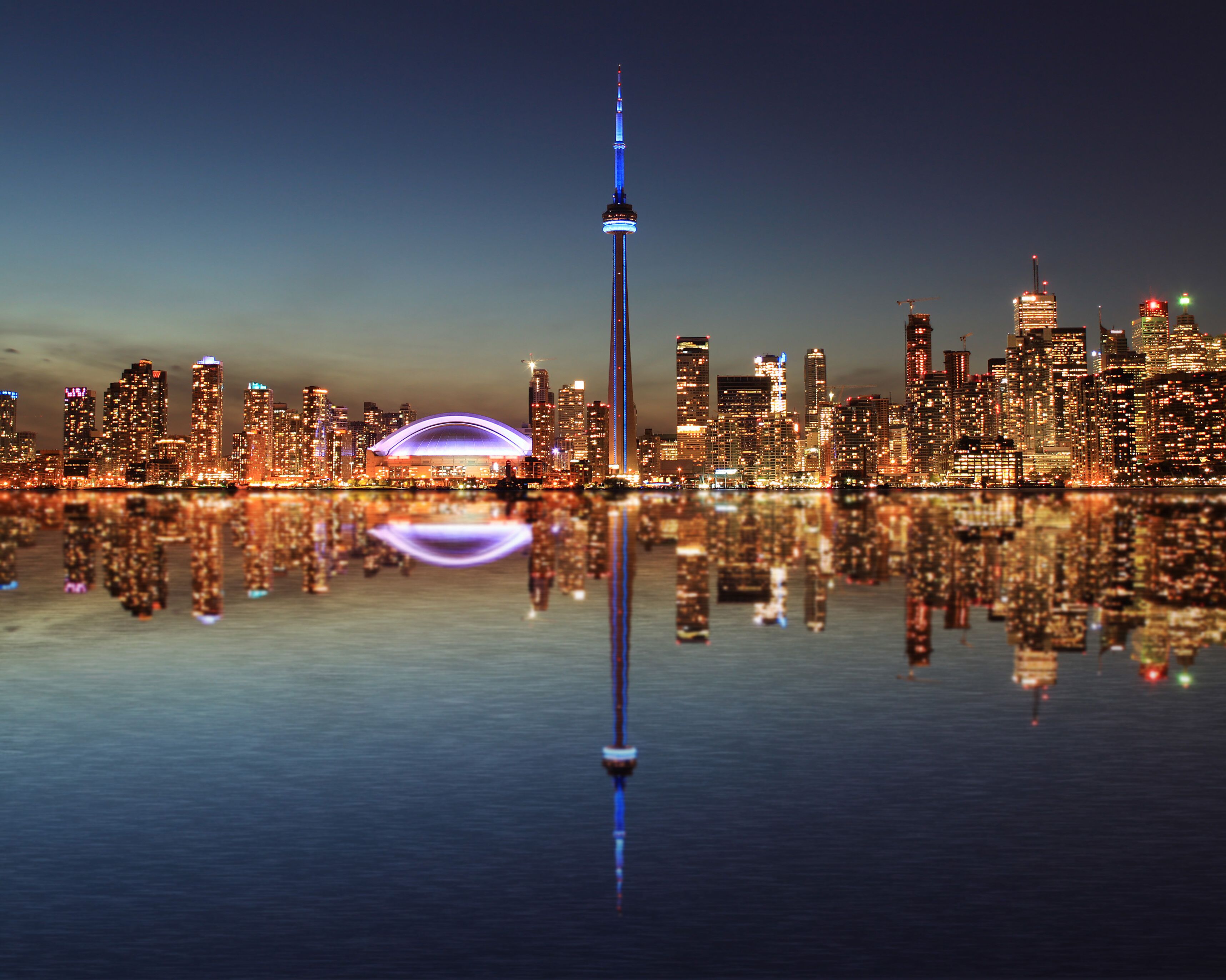 Toronto Skyline at night with a reflection in Lake Ontario. 