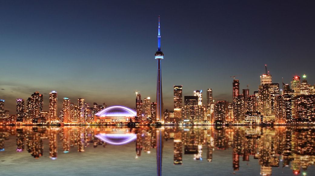 Toronto Skyline at night with a reflection in Lake Ontario.