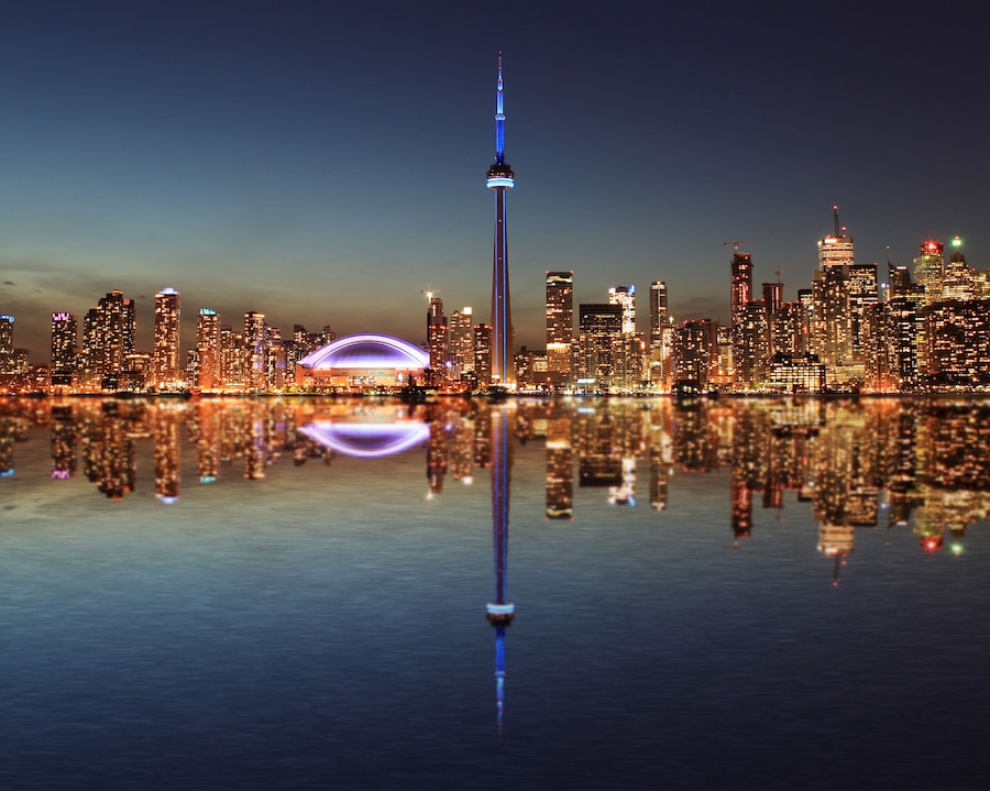 Toronto Skyline at night with a reflection in Lake Ontario.