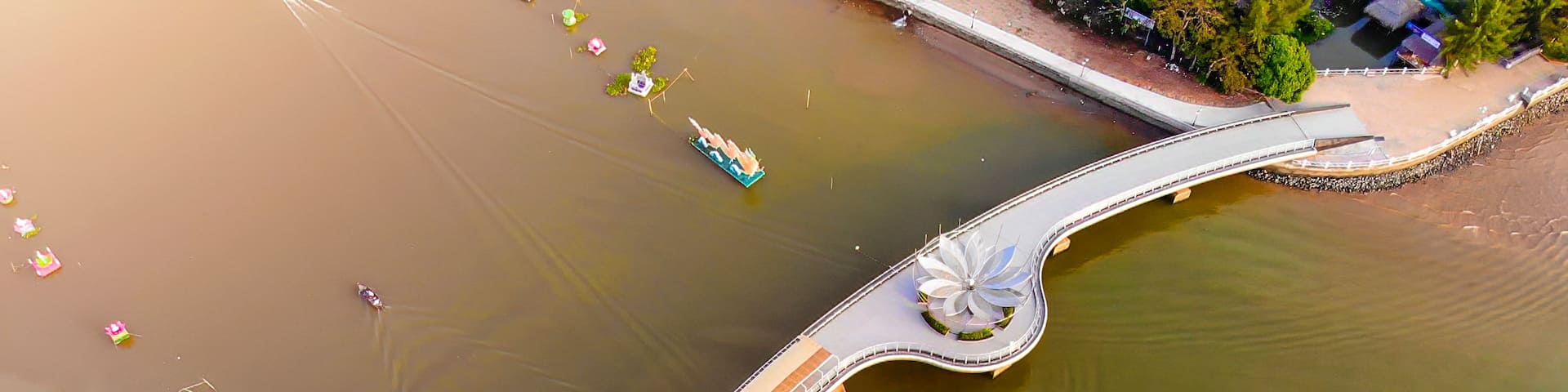 A bridge with a flower-like design over a body of water.
