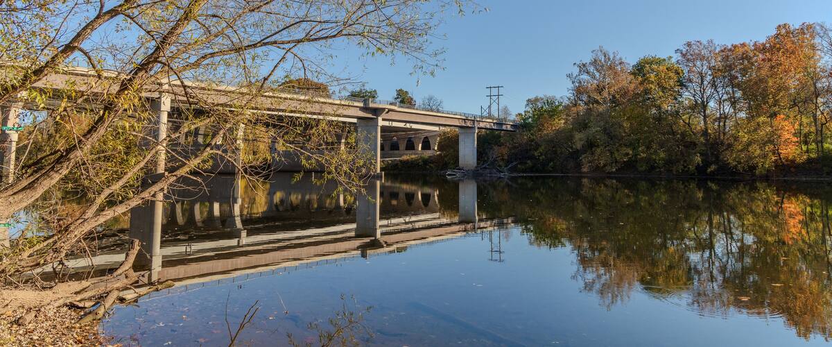 A bridge over a river with trees in the background