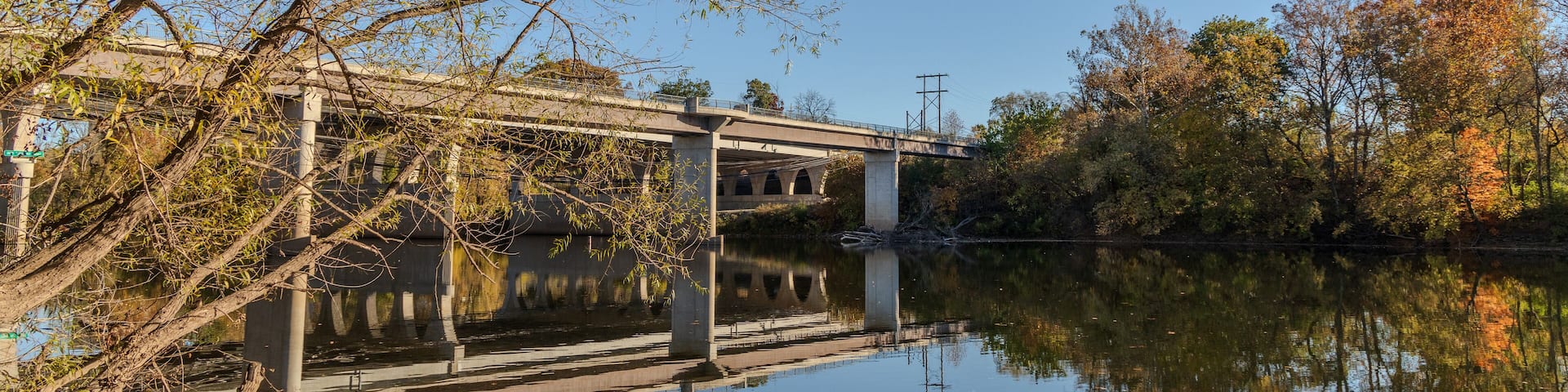 A bridge over a river with trees in the background