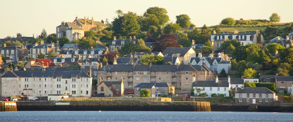 A coastal town with historic buildings and a waterfront.