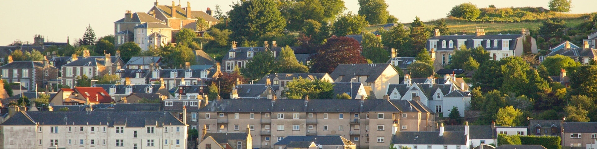 A coastal town with historic buildings and a waterfront.