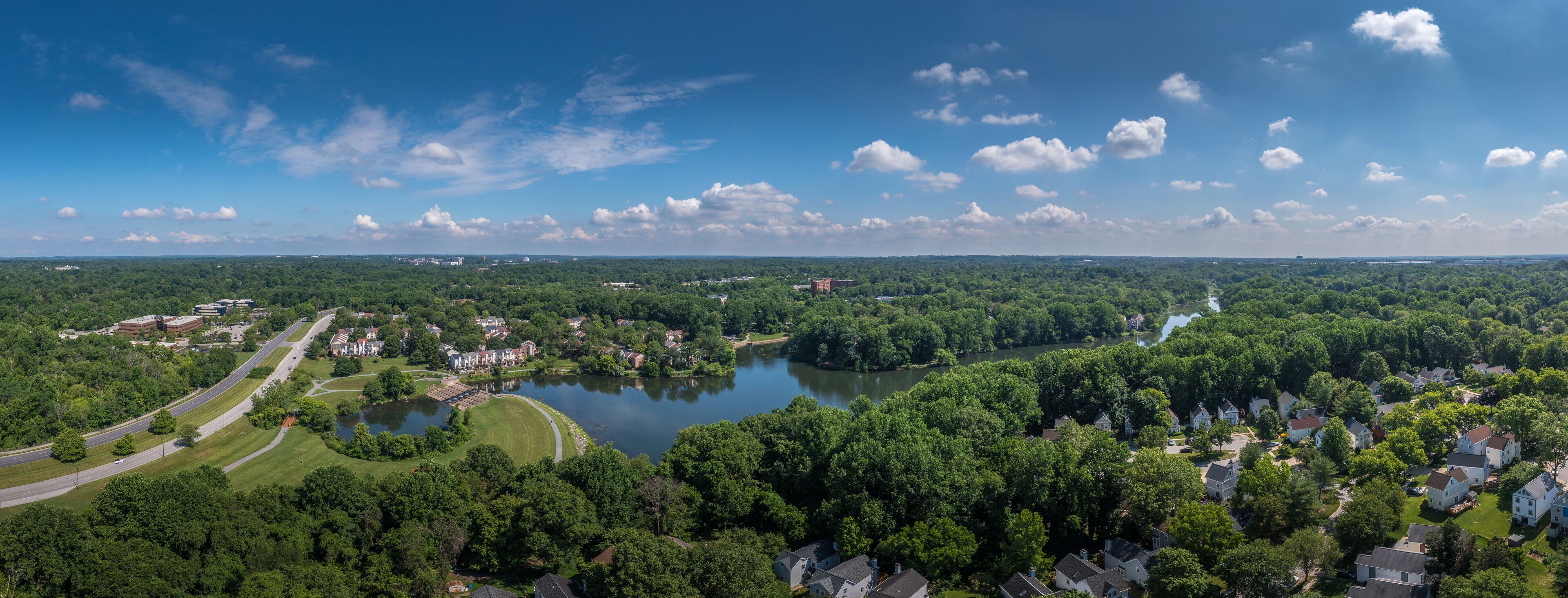Aerial panorama of single family homes and town house neighborhoods around Lake Elkhorn, a manmade lake in Owen Brown village in Columbia Maryland USA