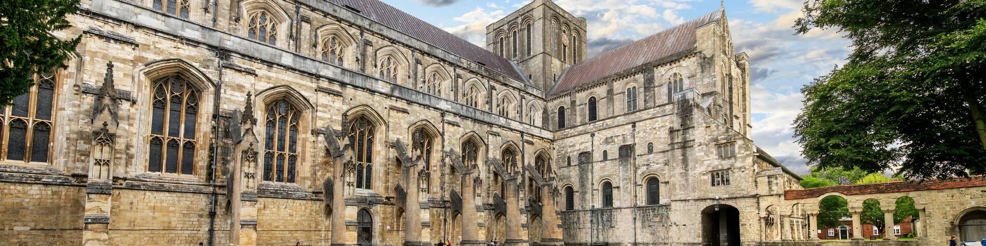 A historic building with large arched windows and a courtyard.