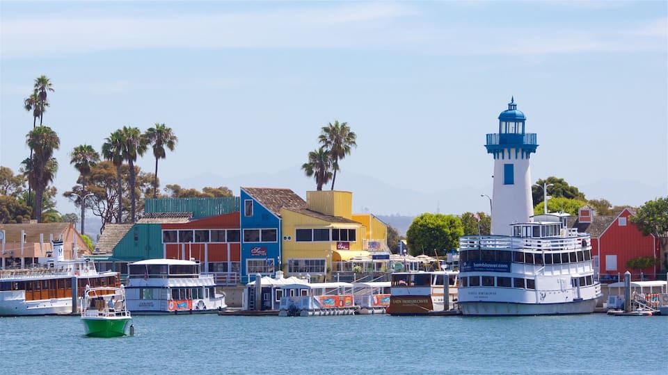 A harbor with colorful buildings, a lighthouse, and boats.
