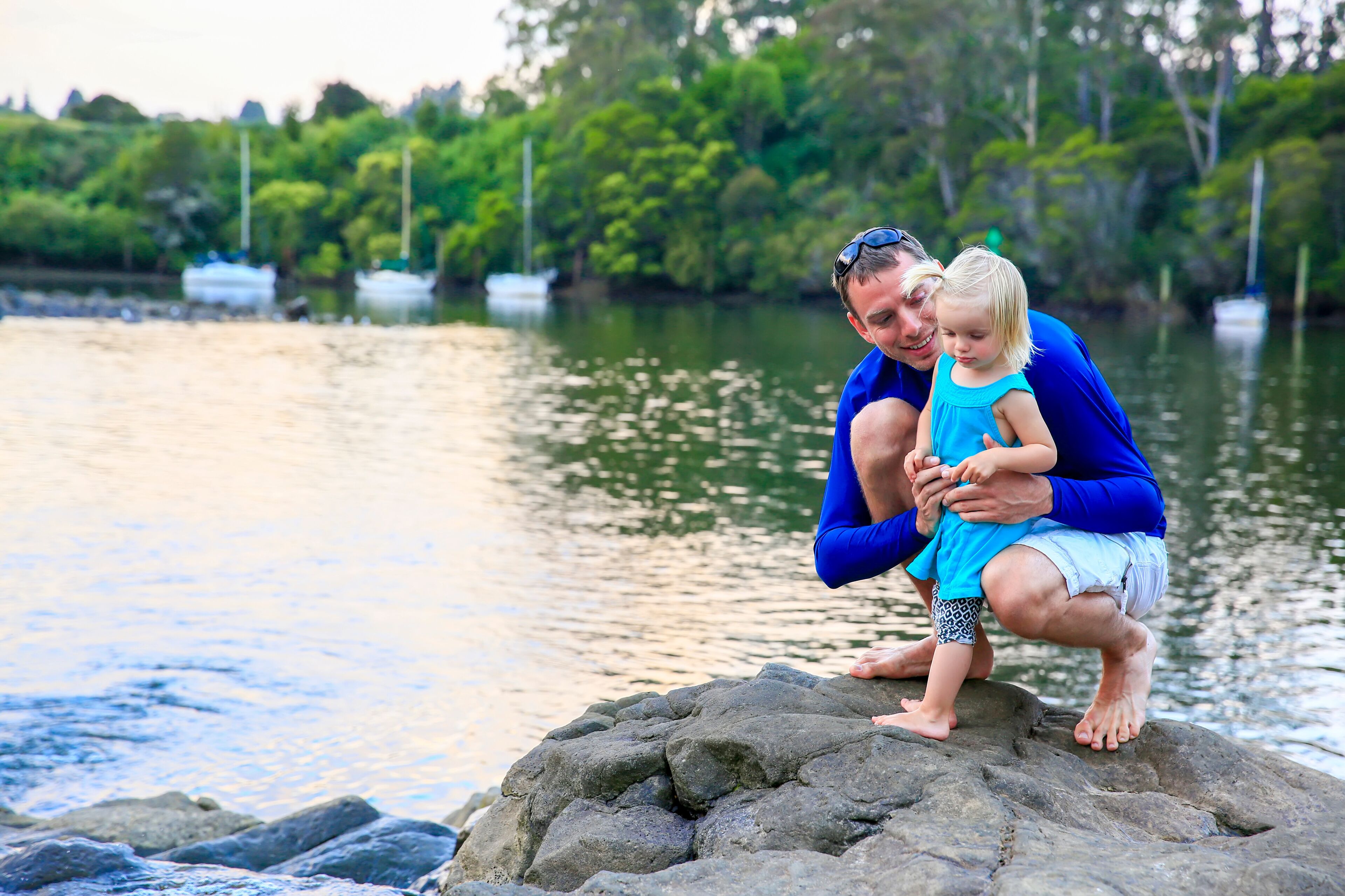 Father with his daughter having fun at Kerikeri river, New Zealand