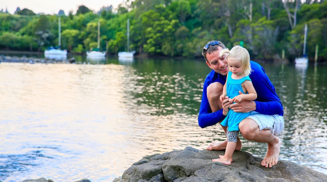Father with his daughter having fun at Kerikeri river, New Zealand