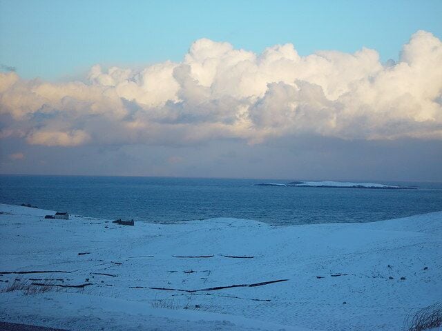 Treawick, Whalsay, Shetland. Croft houses at Treawick are no longer lived in. In the 1930s when the road from Symbister to Isbister was being planned the families at Treawick didn't want the road through their community as they thought it would change them. The road by-passed Treawick. The families later moved out to other parts of Whalsay. In the background are the islets of Flaeshans of Rumble and Rumble