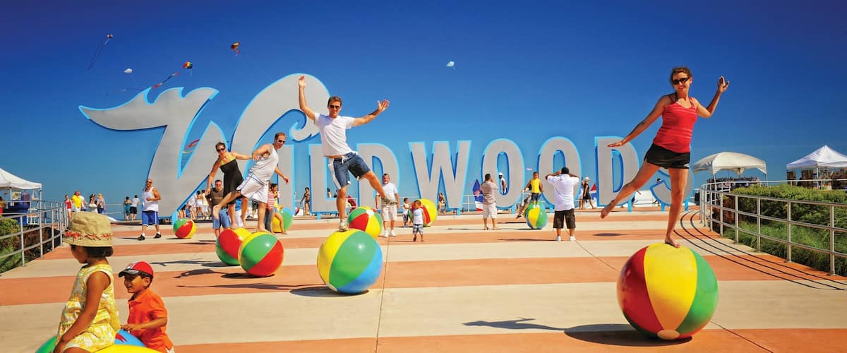 Wildwood showing a playground, signage and performance art
