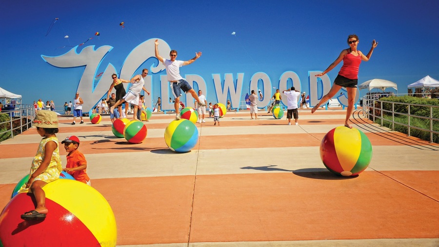 Wildwood showing a playground, signage and performance art