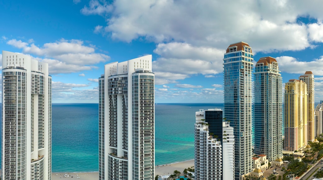 Aerial view of Sunny Isles Beach city with luxurious highrise hotels and condos on Atlantic ocean shore. American tourism infrastructure in southern Florida