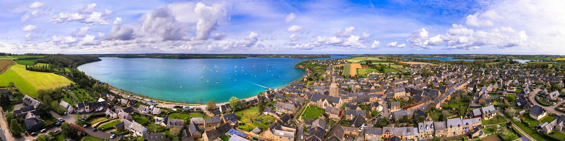 A coastal town with a harbor, houses, and a church.