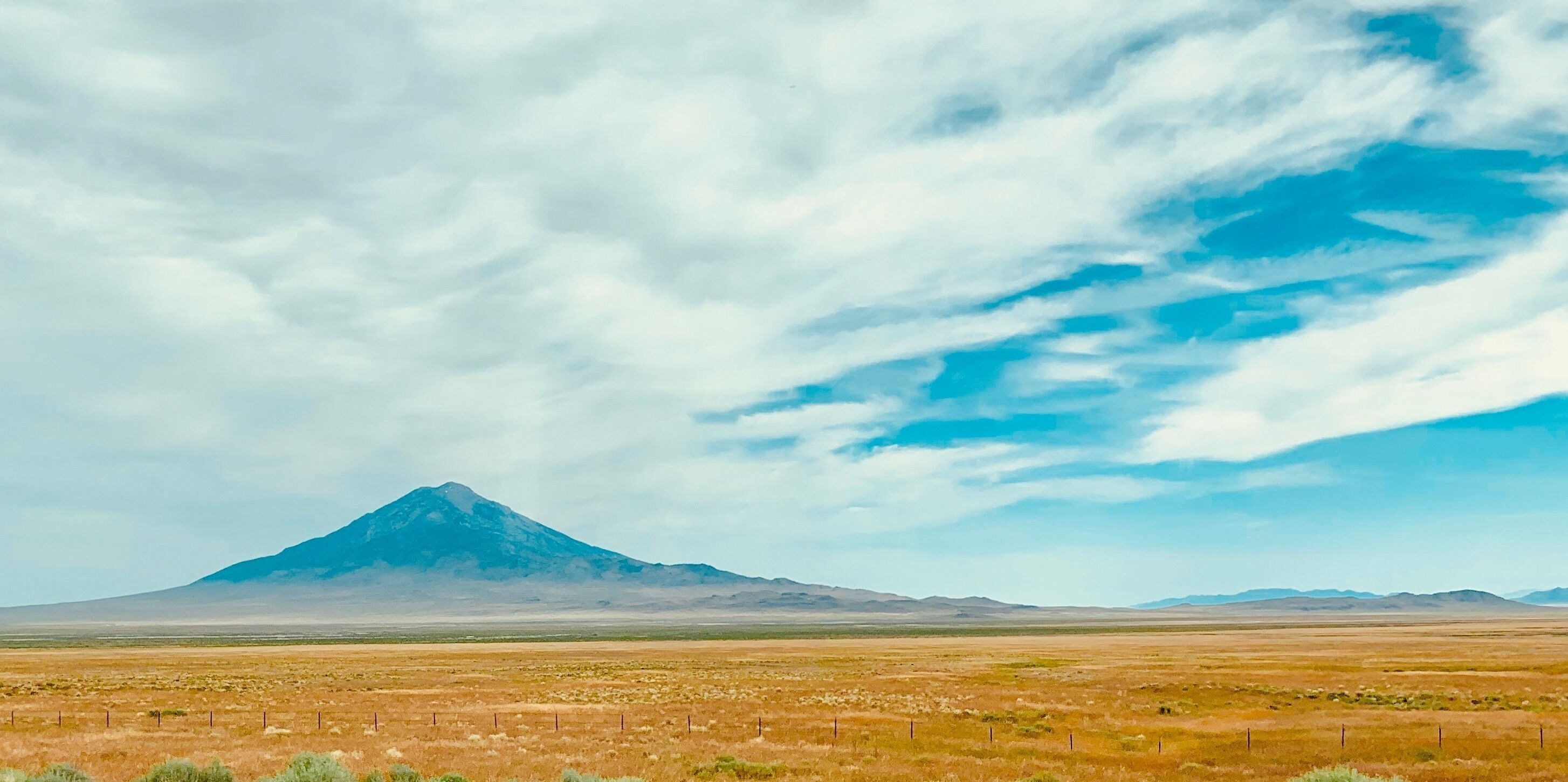 Almost perfect conical shaped mountain while driving through the I-80 along Wendover Nevada. 
#Nature