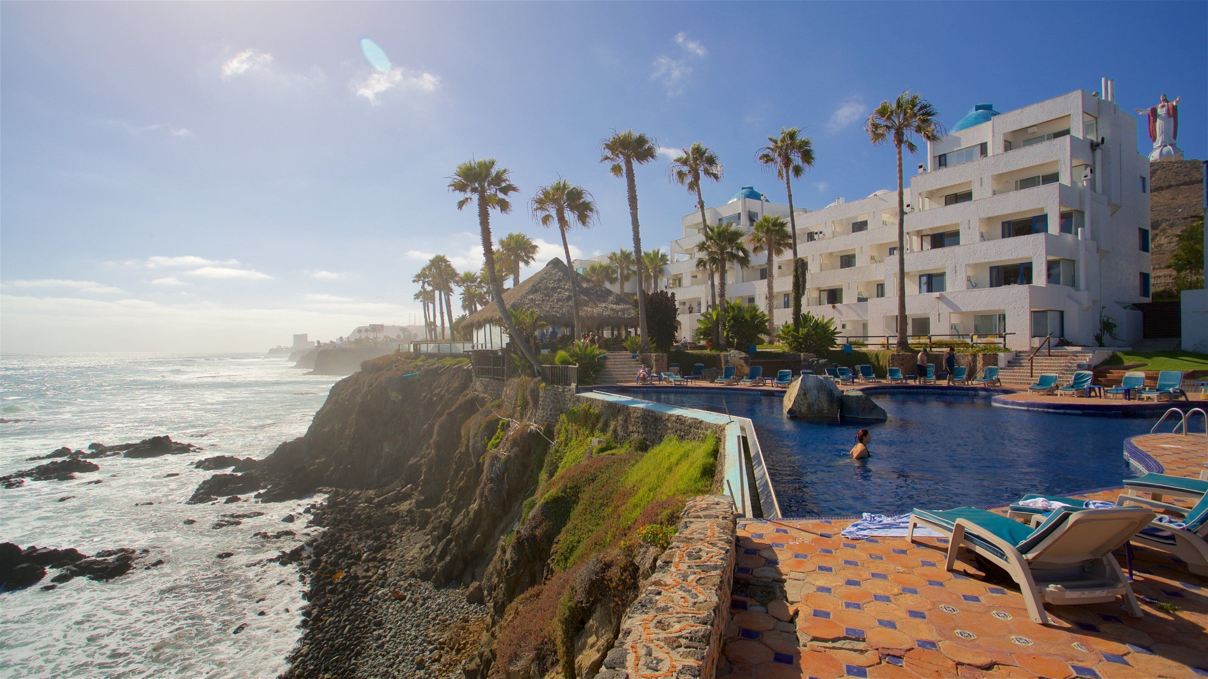 Rosarito showing rugged coastline, a pool and a luxury hotel or resort