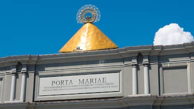 A golden dome with a circular emblem on top, and a sign below that reads "PORTA MARIAE".