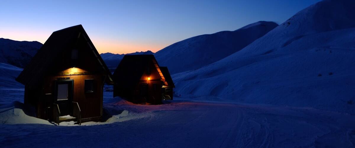 Peaceful winter morning in the #mountains with the warm glow of cozy cabins. #winterescape #wanderlust #alaska #hatcherpass #beforetheavalanche #mountain #dawn