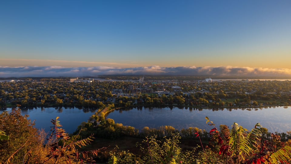 A Scenic View Of A Town Along The Mississippi River with Fog Clouds On The Horizon
