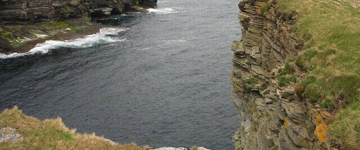 Stanger Head. Looking out to the mouth of a narrow inlet, with an intrepid geographer on the tip of Stanger Head taking pictures in the opposite direction.