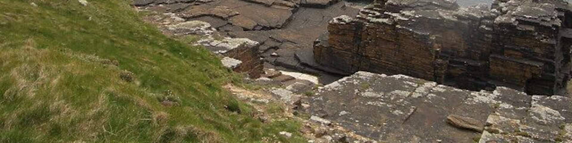 Cliffs and rocks. Looking along the coast past the mouth of Bis Geos