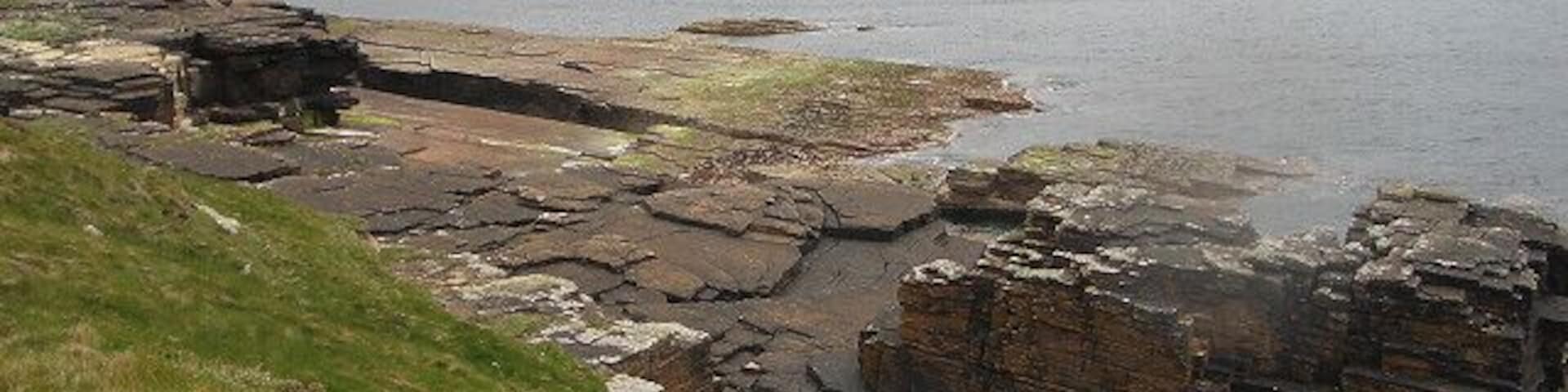 Cliffs and rocks. Looking along the coast past the mouth of Bis Geos