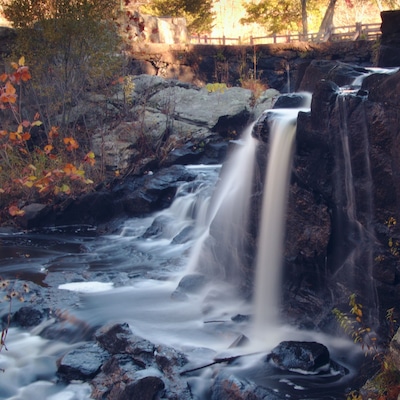 State park with a pretty waterfall and a covered bridge.