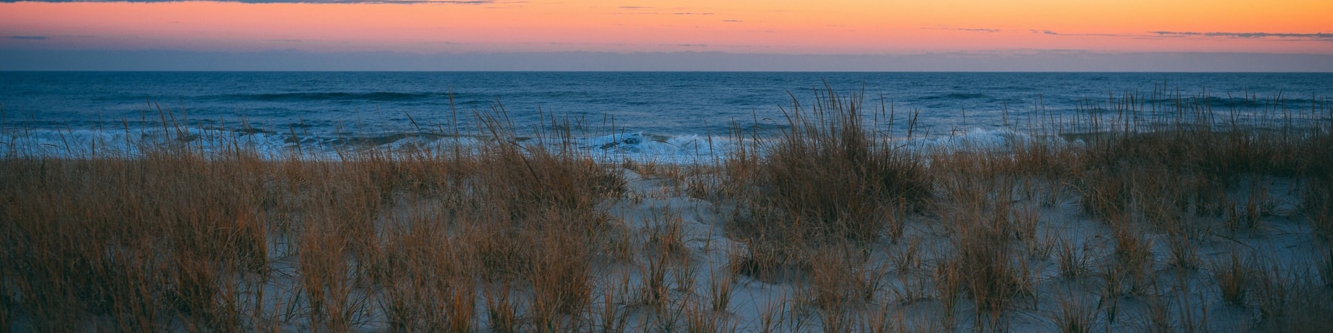 Sand dunes and the Atlantic Ocean at sunset, at Smith Point, Fire Island, New York