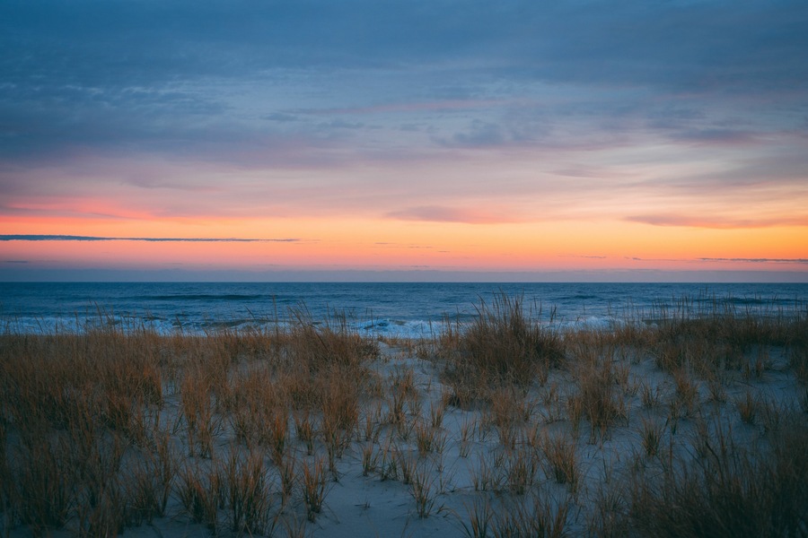 Sand dunes and the Atlantic Ocean at sunset, at Smith Point, Fire Island, New York