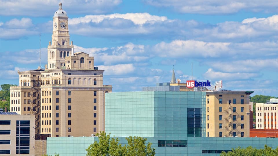 A historic building with a clock tower and a modern glass building with a US Bank sign.