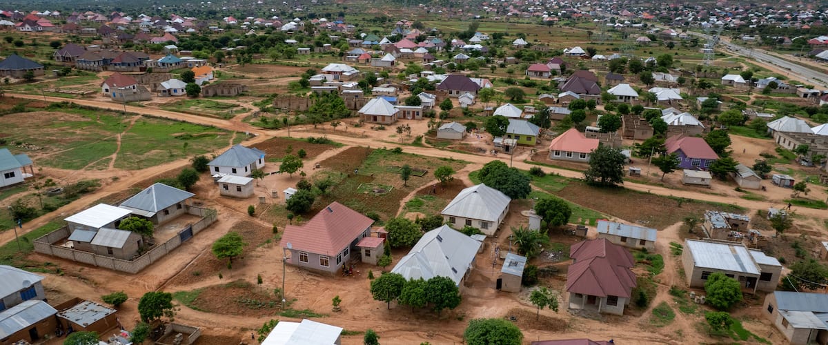 A rural settlement with houses, roads, and surrounding greenery.