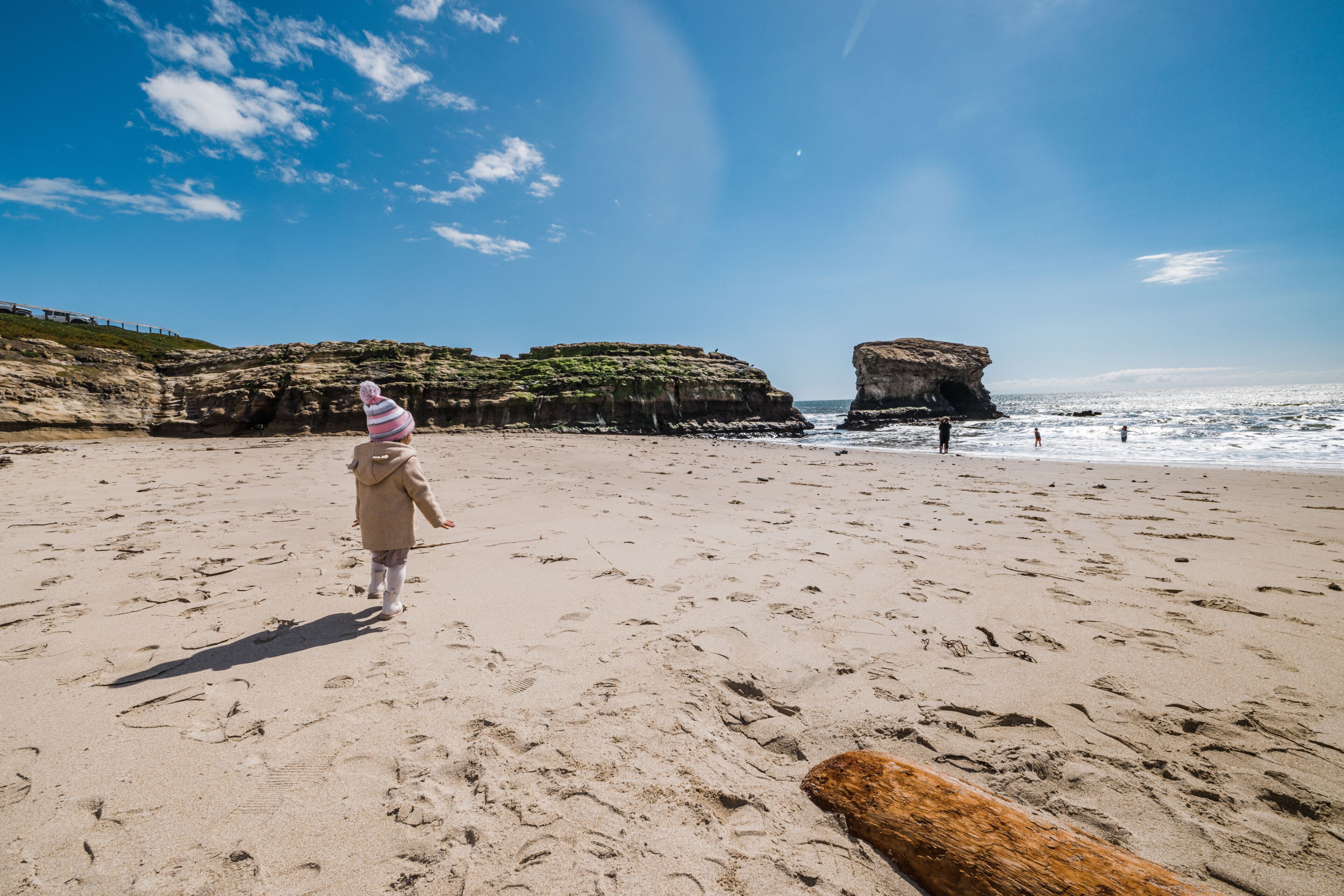 Family walking on beach in Santa Cruz, California