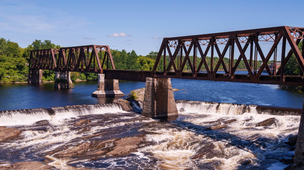 Ticonic Falls in Waterville, Maine, flows beneath the historic Two Cent Bridge, where the Kennebec and Sebasticook Rivers meet—once the heart of Teconnet, a vital Native American trading village