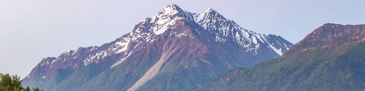 THIS is midnight in Alaska right now! I shot this at a place called Reflections Lake. It's just off the Glenn Highway in between Anchorage and Wasilla. The walk around the lake is mostly level, but sometimes gets washed out by high tide. A manmade lookout tower about halfway along the trail provides a stunning view of the Palmer Hay Flats. You can also access the Knik River from this highway exit.