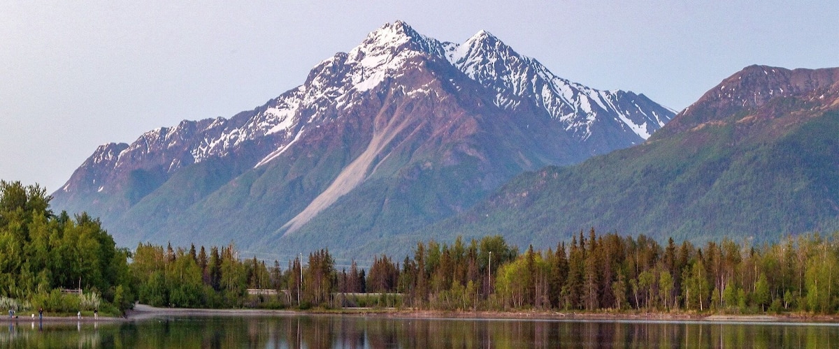 THIS is midnight in Alaska right now! I shot this at a place called Reflections Lake. It's just off the Glenn Highway in between Anchorage and Wasilla. The walk around the lake is mostly level, but sometimes gets washed out by high tide. A manmade lookout tower about halfway along the trail provides a stunning view of the Palmer Hay Flats. You can also access the Knik River from this highway exit.