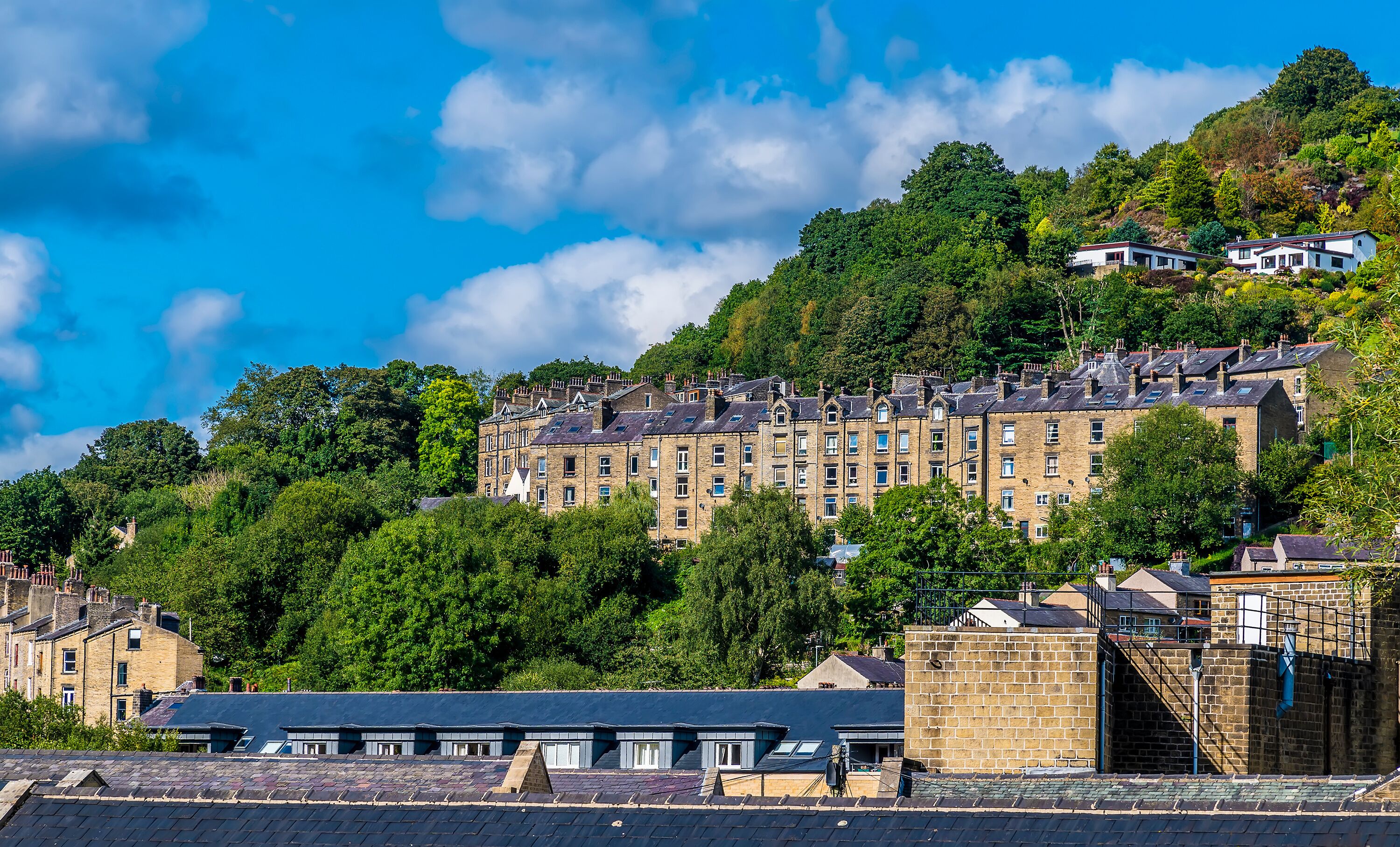 A view of terrace buildings on the valley side of Hebden Bridge, Yorkshire, UK in summertime