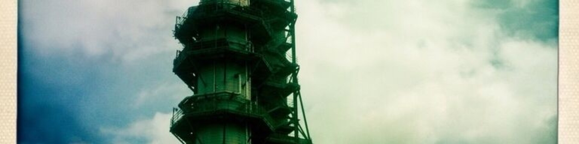 A beautiful, industrial spire on the side of the road.