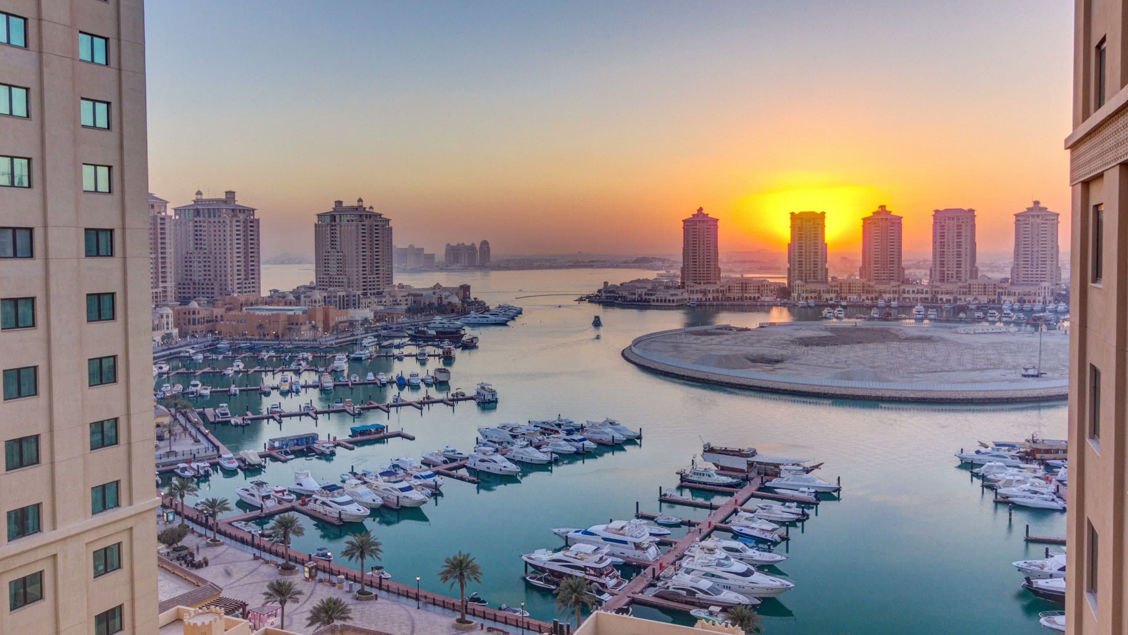Doha featuring a sunset, a city and a bay or harbor