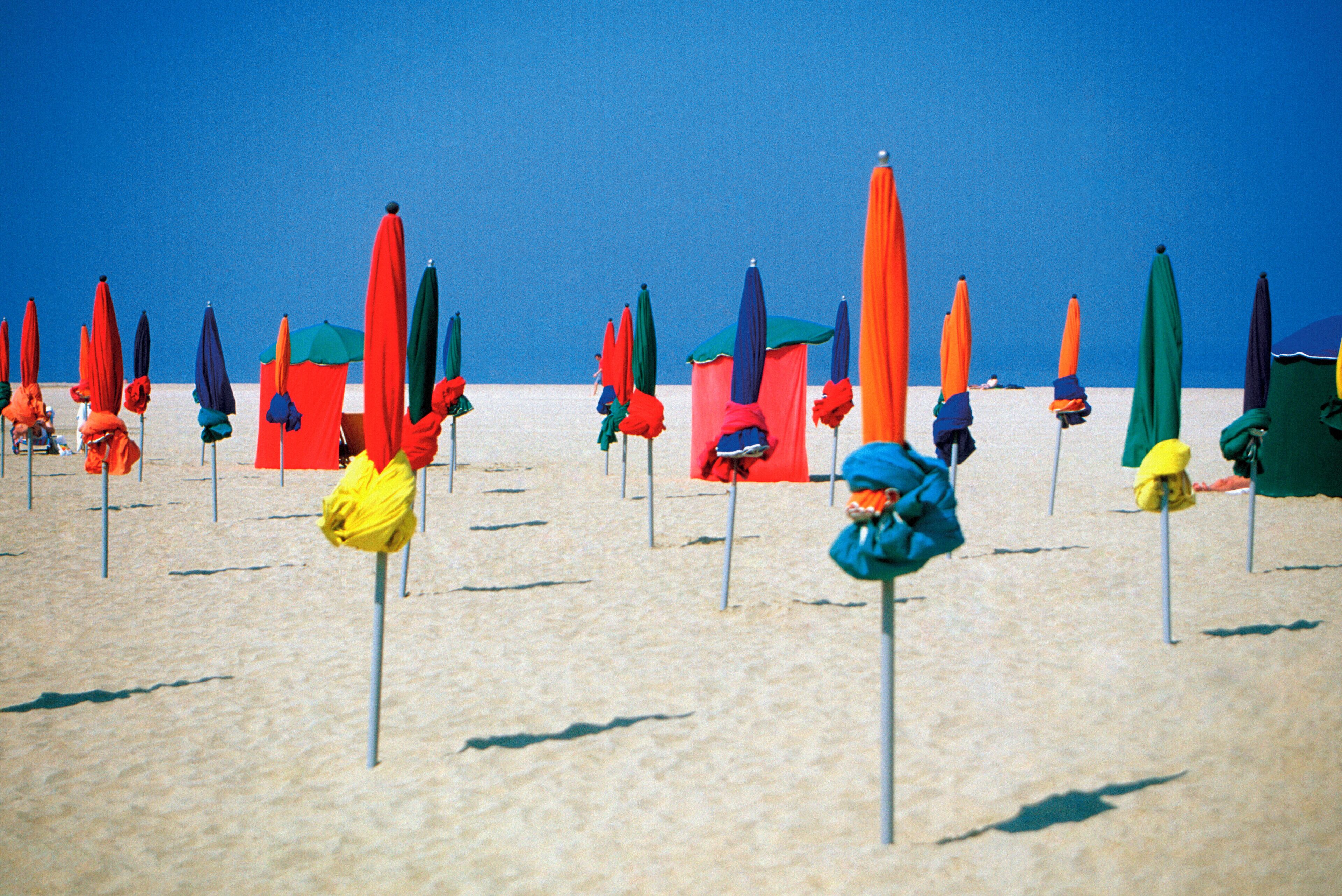 Closed umbrellas on Normandy Beach in North Deauville, France, Europe