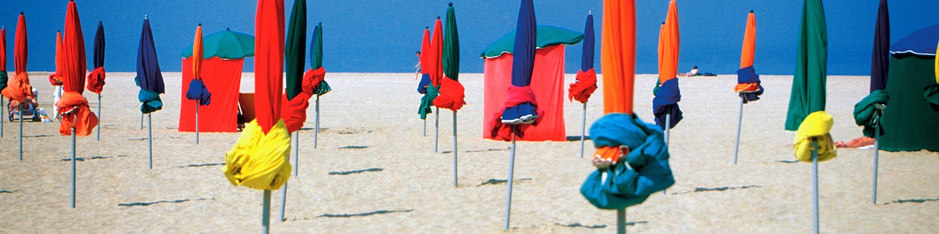 Closed umbrellas on Normandy Beach in North Deauville, France, Europe