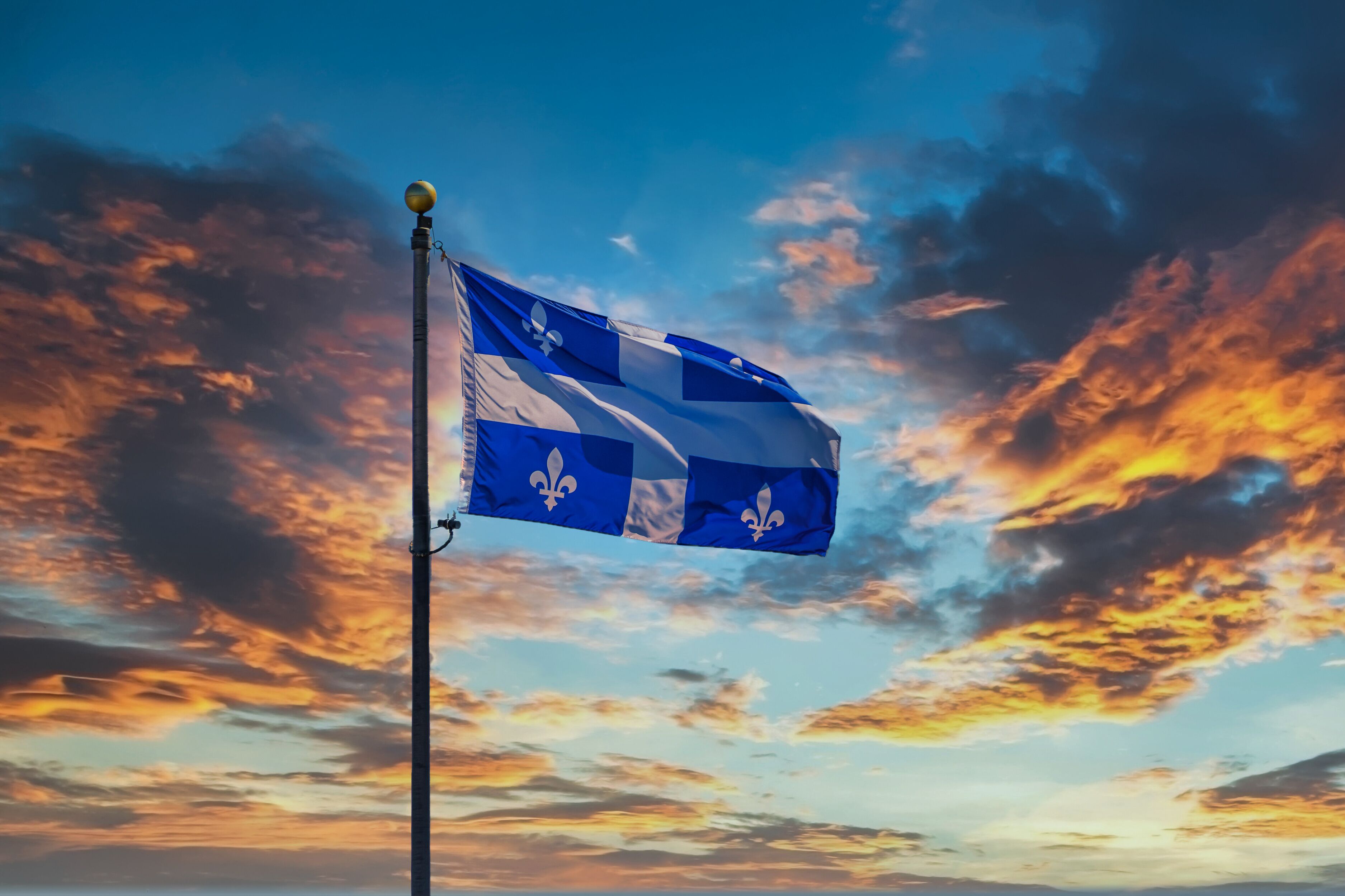 The Flag of Quebec flying against the sky