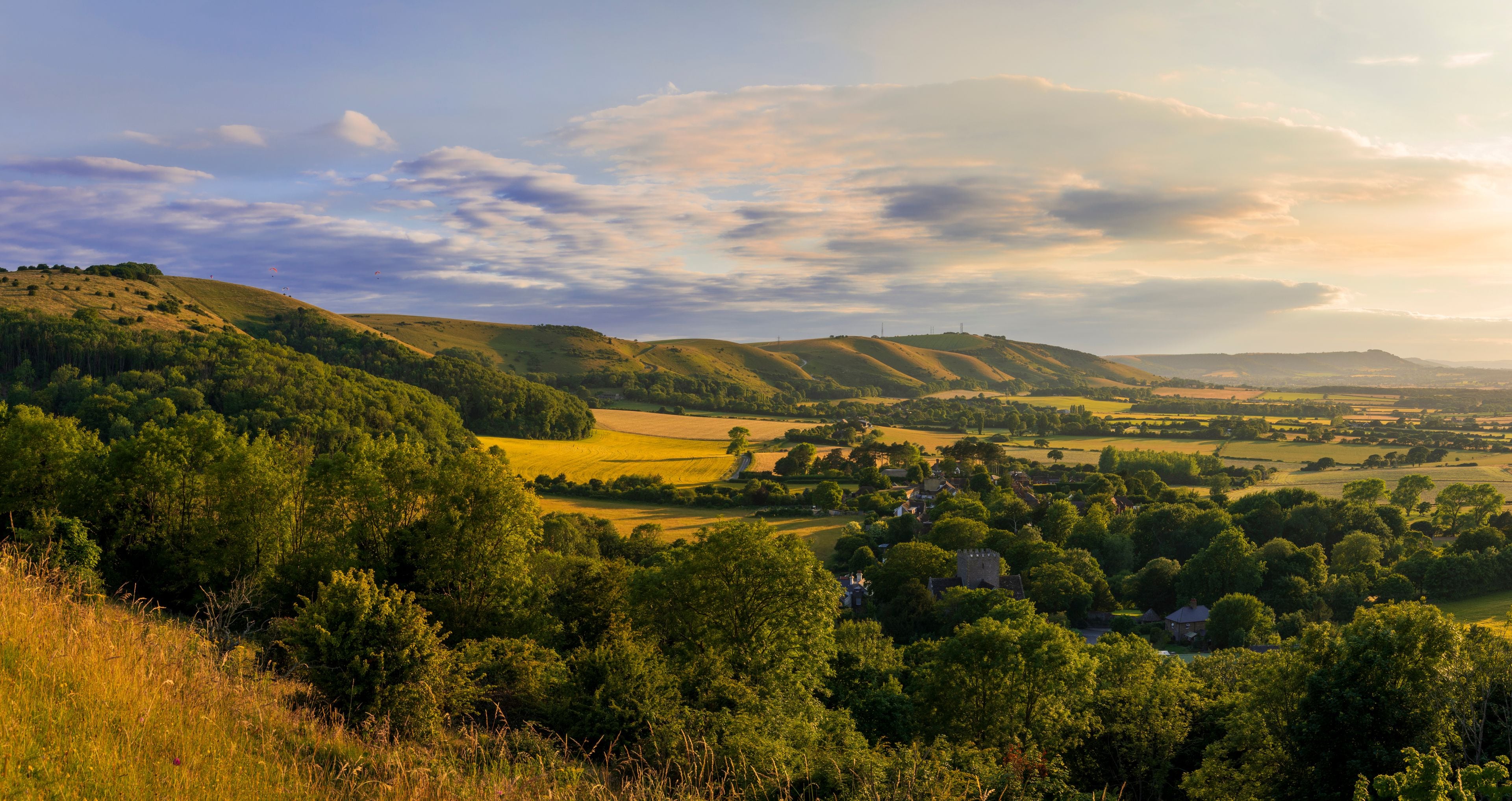 Rolling hills, a village, and a castle.