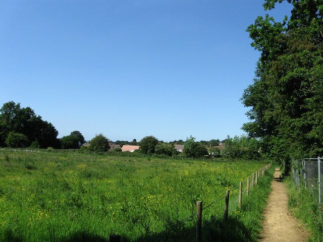 Diverted Footpath Abbey House is currently being redeveloped so the footpath that ran through its grounds has now been diverted into the field next to it and been given an all weather surface to boot. Beyond the fence at the end of the field are Storrington's allotments.