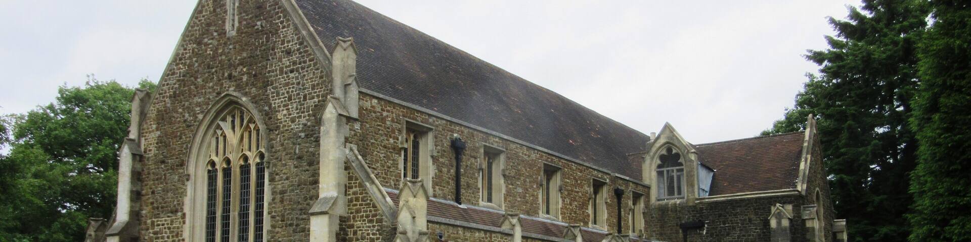 A historic stone church with pointed arches and a steeply pitched roof.